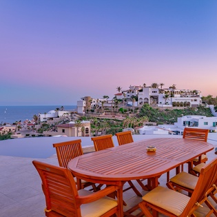 Outdoor seating with ocean view during sunset
