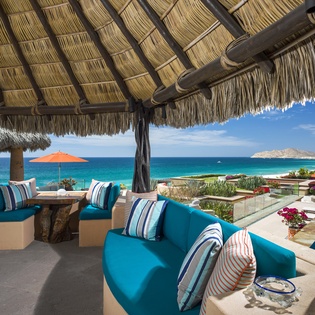 Relax under your private palapa with stunning ocean views, where turquoise waters meet comfortable seating for the perfect tropical escape.