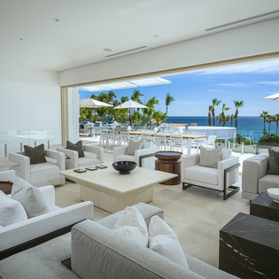 Spacious living area with patio access and ocean views