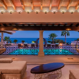 Spacious living area with ocean views and patio access