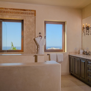 Soak in your luxurious soaking tub while gazing at stunning ocean views through picture windows in this spa-like master bathroom.