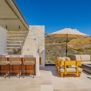 Unwind on your private terrace with desert views, featuring modern outdoor seating and bar area perfect for sunset drinks.