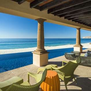 Relax poolside with front-row seats to paradise—your private terrace frames crystal-clear ocean views and pristine sand.