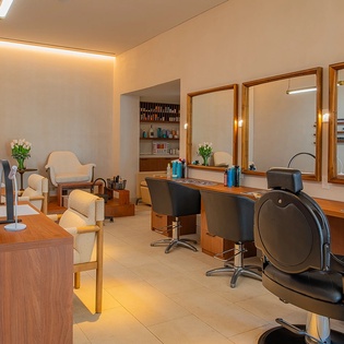 Pamper yourself in the elegant salon with professional styling stations and soothing warm lighting for your perfect getaway refresh.