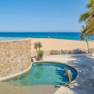 Your private pool awaits with unobstructed beach and ocean views, framed by swaying palms and golden sand—a serene tropical escape just steps from the shore.