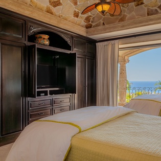 Wake up to stunning ocean views from your luxurious bedroom, where elegant furnishings and a private terrace create the perfect coastal retreat.