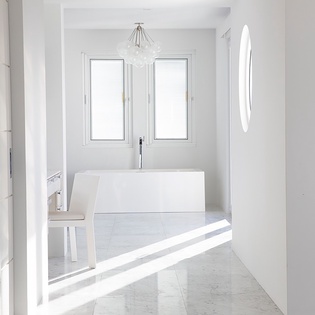 Step into your serene spa-like bathroom sanctuary, where minimalist elegance meets ultimate relaxation with a luxurious soaking tub bathed in natural light.
