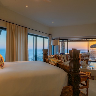 Unwind in your oceanfront bedroom where stunning sea views and a cozy fireplace create the perfect sanctuary for relaxation.