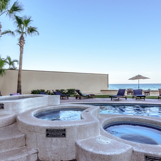 Multiple jacuzzies and pool with ocean views