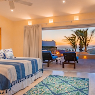 Bedroom suite with patio access and ocean views
