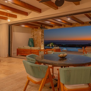 Dine under stunning exposed beams as your table overlooks breathtaking ocean views. This open-concept space blends indoor comfort with outdoor beauty perfectly.