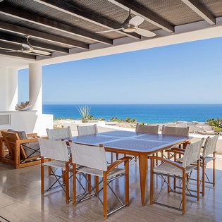 Host memorable gatherings with sweeping sea views from your private terrace, where indoor and outdoor living blend seamlessly under a striking beamed ceiling.