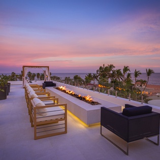 Outdoor seating with firepit during sunset