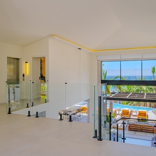 Step into your bright, modern sanctuary where sleek design meets stunning ocean views and poolside relaxation.