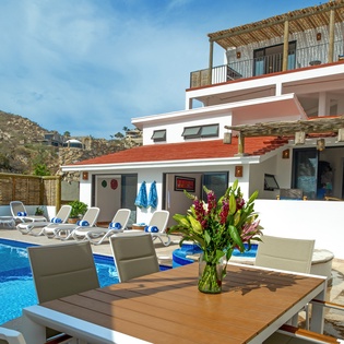 Soak up Mediterranean sunshine by your private pool, where outdoor dining meets mountain views in this stunning hillside retreat.