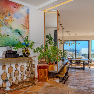 Step into an artfully designed space where vibrant decor meets stunning ocean views. Relax in your thoughtfully appointed living area with coastal breezes just beyond the glass doors.