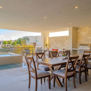 Your spacious covered terrace features a grand dining table for eight and outdoor kitchen, perfect for memorable meals with pool views.