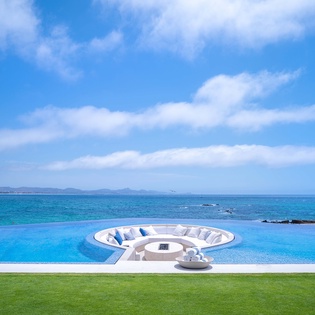 Patio with fire pit and infinity pool with ocean views