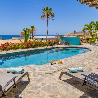Sunny poolside patio with ocean views