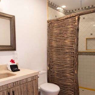 Step into your private sanctuary with hand-carved bamboo details, stone vanity, and artisan tilework creating a spa-like retreat.
