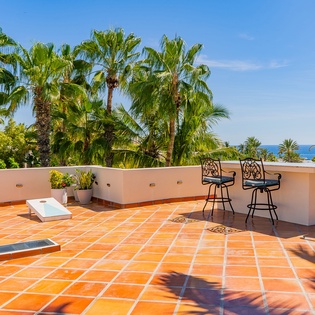 Rooftop with ocean views, outdoor seating, and games