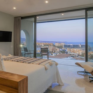 Bedroom suite with patio access and ocean views