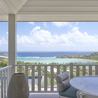Elevated terrace offering sweeping ocean and island views across pristine turquoise waters and lush tropical coastline.