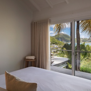Wake up to turquoise waters framing tropical palms just beyond your window. Soft linens, bright ocean views, and Caribbean breezes create your perfect island retreat.