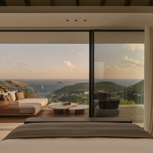 Wake up to breathtaking panoramic views through floor-to-ceiling windows, where your private terrace overlooks rolling hills and sparkling waters.