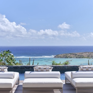 Stunning ocean views and turquoise waters create the perfect backdrop for your tropical getaway relaxation.