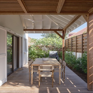 Your private terrace invites relaxed dining under dappled sunlight, where natural wood and tropical greenery create the perfect outdoor retreat.