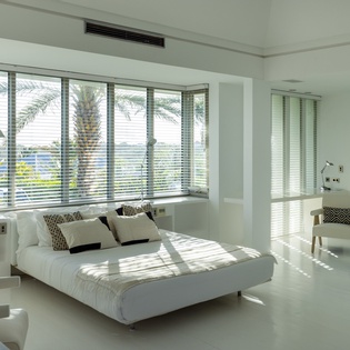 Drift off in your sun-drenched bedroom with tropical palm views, where crisp white linens and gentle breezes create pure serenity.