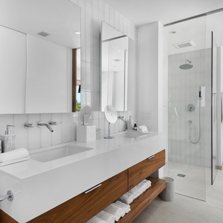 Your private spa-like bathroom features a floating vanity, rainfall shower, and crisp white finishes for a refreshing start to each day.
