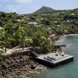 Tropical coastal property nestled among rolling hills with private dock and crystal-clear Caribbean waters.