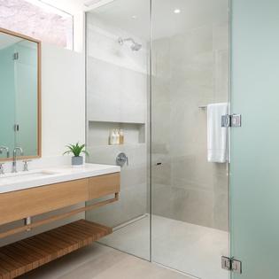 Unwind in your spa-like bathroom featuring a spacious walk-in shower with rainfall head and elegant floating vanity.