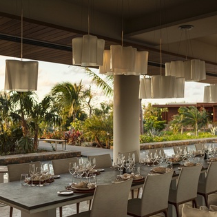 Savor exceptional cuisine at this elegant open-air restaurant with tropical garden views and sophisticated lighting.