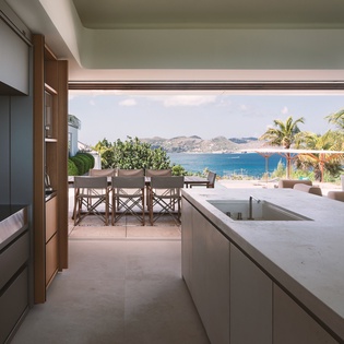 Your gourmet kitchen opens to stunning sea views and tropical breezes, where cooking becomes a joy with paradise as your backdrop.