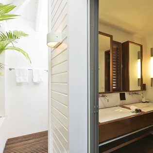 Step into your spa-like bathroom where natural light streams in from your private garden sanctuary, creating a serene retreat.