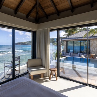 Wake up to endless ocean views from your luxurious bedroom, where floor-to-ceiling windows frame paradise and your private pool beckons.