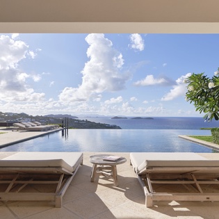 Recline on your private pool deck where an infinity edge meets endless ocean vistas, perfect for sun-soaked relaxation or quiet moments beneath dramatic tropical skies.