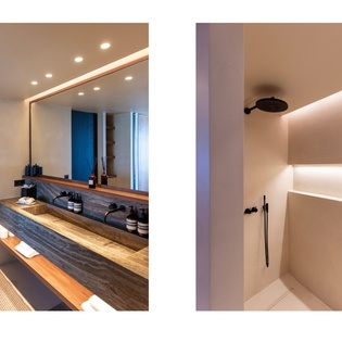 Luxurious bathroom with elegant stone vanity and rainfall shower await your refreshing moments.