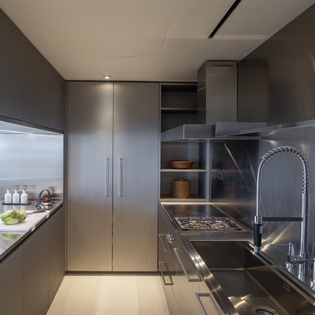 Your sleek modern kitchen features premium stainless steel appliances and ample counter space for preparing memorable meals during your stay.