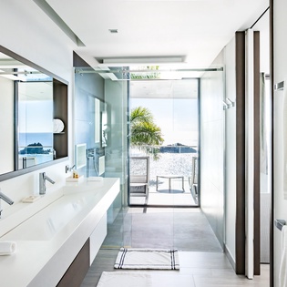 Your spa-like ensuite features sleek dual vanities and glass shower, opening seamlessly to your private terrace.
