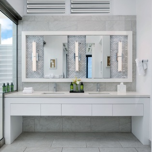 Step into your elegant ensuite, where dual vanities and a walk-in shower await beneath crisp, modern lines and soft natural light.