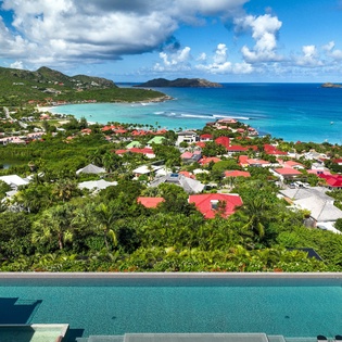 Stunning aerial view showcasing the tropical paradise surrounding this Caribbean coastal community with pristine turquoise waters and lush hillsides.