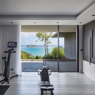 Your private fitness room overlooks stunning turquoise waters, where morning workouts become moments of pure inspiration with ocean views.
