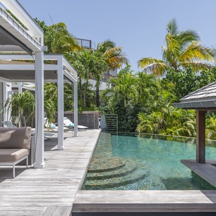 Slip into your private pool surrounded by swaying palms and modern tropical luxury—your perfect island escape awaits.