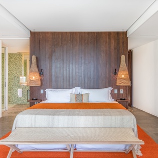 Unwind in your serene bedroom featuring a plush king bed, warm wood accents, and elegant woven pendant lights creating perfect ambiance.