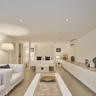 Your elegant suite combines comfort and style with plush seating, ambient lighting, and calming coastal decor for the perfect getaway.