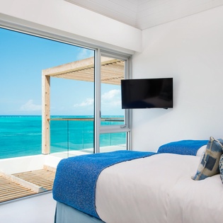 Wake up to stunning turquoise waters right outside your bedroom door, with a private terrace perfect for morning coffee.